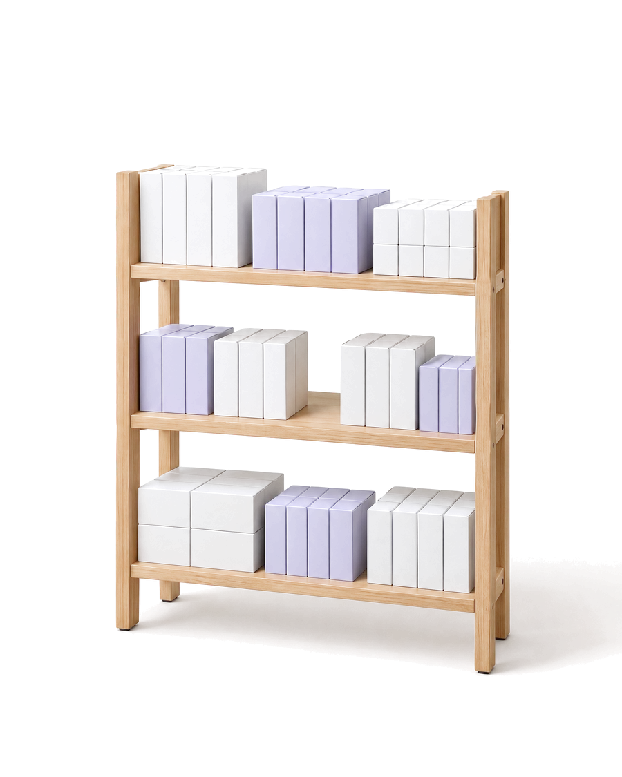 A tidy pharmacy shelf of boxes with one gap to reorder