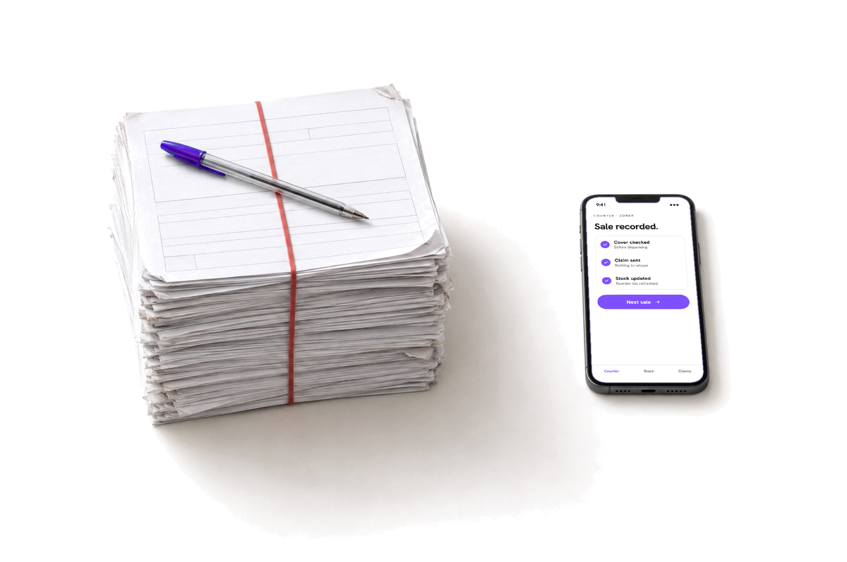 A tall stack of paper claim forms next to a phone showing a sale recorded and its claim sent