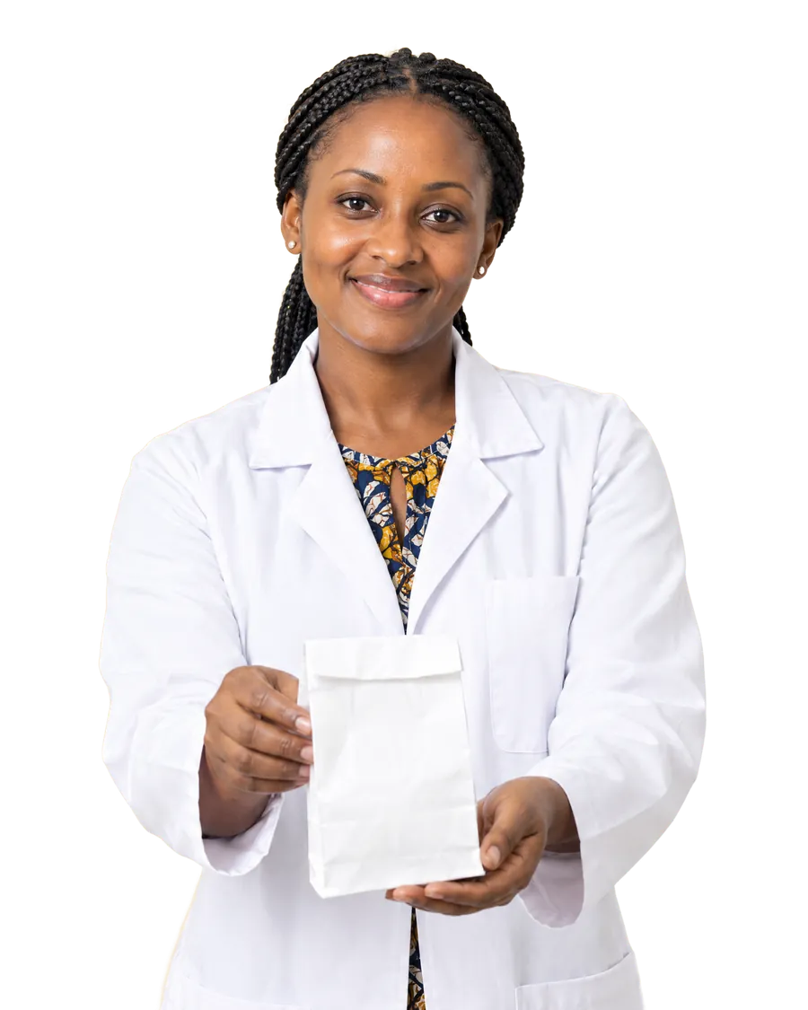 A smiling pharmacist in a white coat holds out a paper pharmacy bag